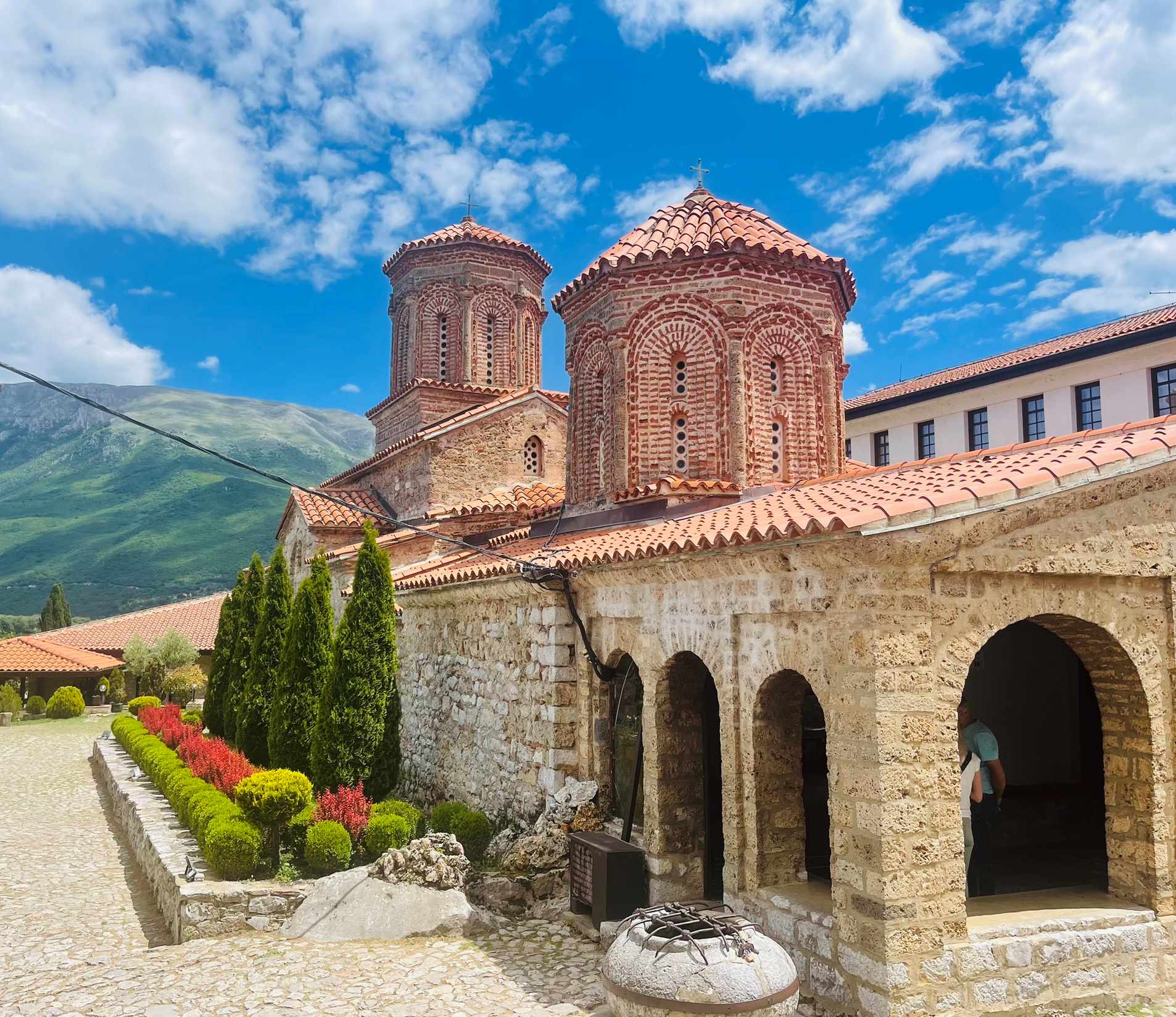 National Park building in Galichica, North Macedonia with hills in background and colorful plantings next to the building